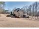 Expansive backyard featuring a well-maintained lawn, a deck, and mature trees providing ample shade at 305 Glengarry Chase, Covington, GA 30014