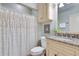 Cozy bathroom featuring a granite countertop, decorative shower curtain and updated fixtures at 305 Glengarry Chase, Covington, GA 30014