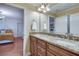 Bathroom features double sink vanity with granite countertop with wood cabinets, adjoining bedroom view at 305 Glengarry Chase, Covington, GA 30014