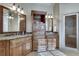 Luxurious bathroom featuring dual vanities, granite countertops, and a glass-enclosed shower at 305 Glengarry Chase, Covington, GA 30014