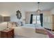 Inviting bedroom featuring a plush bed, crystal lamp, and a decorative mirror at 305 Glengarry Chase, Covington, GA 30014