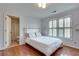 Bedroom with an ensuite bathroom, hardwood floors, shuttered windows, and a full-size bed at 305 Glengarry Chase, Covington, GA 30014