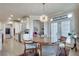 Charming dining area featuring a stylish light fixture and access to the kitchen and living spaces at 305 Glengarry Chase, Covington, GA 30014