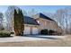Attractive exterior elevation with a large driveway and attached two-car garage at 305 Glengarry Chase, Covington, GA 30014