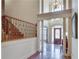 Grand foyer with hardwood floors, high ceilings, elegant staircase, and a decorative front door at 305 Glengarry Chase, Covington, GA 30014