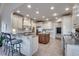 Modern kitchen with granite counters, stainless steel appliances, custom cabinetry, and bar seating at 305 Glengarry Chase, Covington, GA 30014