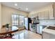 Bright kitchen with stainless steel appliances, wood cabinets, and a window with a view at 305 Glengarry Chase, Covington, GA 30014