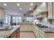 Spacious kitchen with granite countertops, custom cabinets, a center island, and modern appliances at 305 Glengarry Chase, Covington, GA 30014