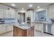 Well-lit kitchen featuring an island, stainless steel appliances, and ample cabinet space at 305 Glengarry Chase, Covington, GA 30014