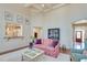 Bright living room with coffered ceilings, open to the kitchen, and elegant seating arrangement at 305 Glengarry Chase, Covington, GA 30014