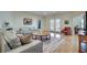 Spacious living room with hardwood floors, neutral colors, a round table, and bright natural light at 305 Glengarry Chase, Covington, GA 30014