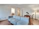 Bright living room with hardwood floors, desk area, and cozy seating at 305 Glengarry Chase, Covington, GA 30014