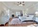 Spacious primary bedroom featuring a fireplace, hardwood floors, and a vaulted ceiling at 305 Glengarry Chase, Covington, GA 30014