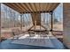 Covered patio featuring seating and a grill, perfect for outdoor entertaining at 305 Glengarry Chase, Covington, GA 30014