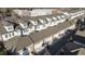 Aerial view of townhomes with brick and gray exteriors, featuring gray roofing and ample parking at 435 Letchas Ln, Alpharetta, GA 30009