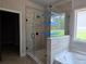 Modern bathroom features a glass-enclosed shower and a soaking tub, offering a luxurious and relaxing experience at 8970 Callaway Dr, Winston, GA 30187