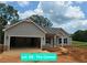 Charming single-story home with gray siding, stone accents, and an attached two-car garage in a residential area at 8970 Callaway Dr, Winston, GA 30187