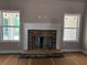 Inviting fireplace with a stone surround and classic white mantle flanked by windows, creating a cozy atmosphere at 8970 Callaway Dr, Winston, GA 30187