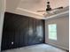 Spacious main bedroom features a decorative accent wall, tray ceiling, and a ceiling fan for added comfort at 8970 Callaway Dr, Winston, GA 30187