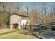 View of home's exterior with a small garage and second story screened-in porch overlooking backyard at 201 Windflower Ct, Canton, GA 30115