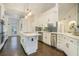 A well-lit kitchen featuring white cabinetry, an island, and modern appliances at 201 Windflower Ct, Canton, GA 30115