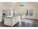 Bright kitchen with white cabinets, stainless steel appliances, a large island, and wood floors at 201 Windflower Ct, Canton, GA 30115