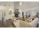 Inviting living room featuring a stone fireplace, hardwood floors, and large windows for natural light at 201 Windflower Ct, Canton, GA 30115
