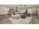 Spacious living room featuring a wet bar, light grey wood flooring, and comfortable seating area at 201 Windflower Ct, Canton, GA 30115