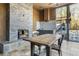 Outdoor dining area with a stone fireplace, a dining table, and an outdoor kitchen area at 201 Windflower Ct, Canton, GA 30115