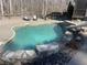 Backyard pool with stone accents and a slide for summer fun at 201 Windflower Ct, Canton, GA 30115