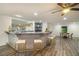 Wet bar with seating, a marble countertop, and decorative shelving at 201 Windflower Ct, Canton, GA 30115