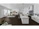 Kitchen with large island, bar seating, white cabinets, stainless steel appliances, and an adjacent dining area at 4213 Legacy Ln # 32, Acworth, GA 30101