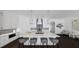 Large kitchen island with bar seating, white cabinets, stainless steel appliances, and modern light fixtures at 4213 Legacy Ln # 32, Acworth, GA 30101