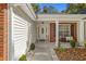 Inviting front porch with white columns and landscaping at 3828 Briarstone Cv, Snellville, GA 30039