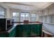 Green cabinets and granite countertops in this galley kitchen at 388 Highway 20 Spur, Cartersville, GA 30121