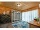 Bathroom featuring a rustic wood-paneled wall and unique storage system with a dark tile accent at 4297 Earney Rd, Woodstock, GA 30188
