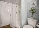 Modern bathroom with a white shower, toilet, and natural light from a window at 4297 Earney Rd, Woodstock, GA 30188