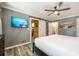 Main bedroom with large TV and sliding barn door at 4297 Earney Rd, Woodstock, GA 30188