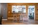 Open kitchen with breakfast bar and rustic wood accent wall at 4297 Earney Rd, Woodstock, GA 30188