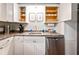Efficient kitchenette with white cabinets, stainless steel dishwasher, and counter space at 4297 Earney Rd, Woodstock, GA 30188