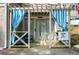 Private patio with seating and blue and white striped curtains for added privacy at 4297 Earney Rd, Woodstock, GA 30188