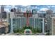 Aerial view of a modern apartment building with a pool and city skyline in the background at 44 Peachtree Nw Pl # 1828, Atlanta, GA 30309