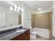 Bathroom with granite vanity, neutral tile, and bathtub at 44 Peachtree Nw Pl # 1828, Atlanta, GA 30309