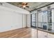 Bright living room with hardwood floors and access to a balcony with city views at 44 Peachtree Nw Pl # 1828, Atlanta, GA 30309