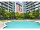 Inviting outdoor pool surrounded by lush landscaping and comfortable seating at 44 Peachtree Nw Pl # 1828, Atlanta, GA 30309