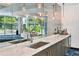 Modern wet bar with a quartz countertop and stylish lighting at 44 Peachtree Nw Pl # 1828, Atlanta, GA 30309