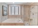 Bathroom with a large walk-in shower and a soaking tub at 4760 Highland Point Dr, Auburn, GA 30011