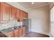 Kitchen boasts granite counters and wood cabinets at 4760 Highland Point Dr, Auburn, GA 30011