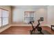 Bright recreation room with hardwood floors and an exercise bike at 4760 Highland Point Dr, Auburn, GA 30011