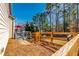 Spacious backyard features wood fence, a gray back deck with patio furniture, and a red umbrella at 115 Greenbrier Way, Canton, GA 30114